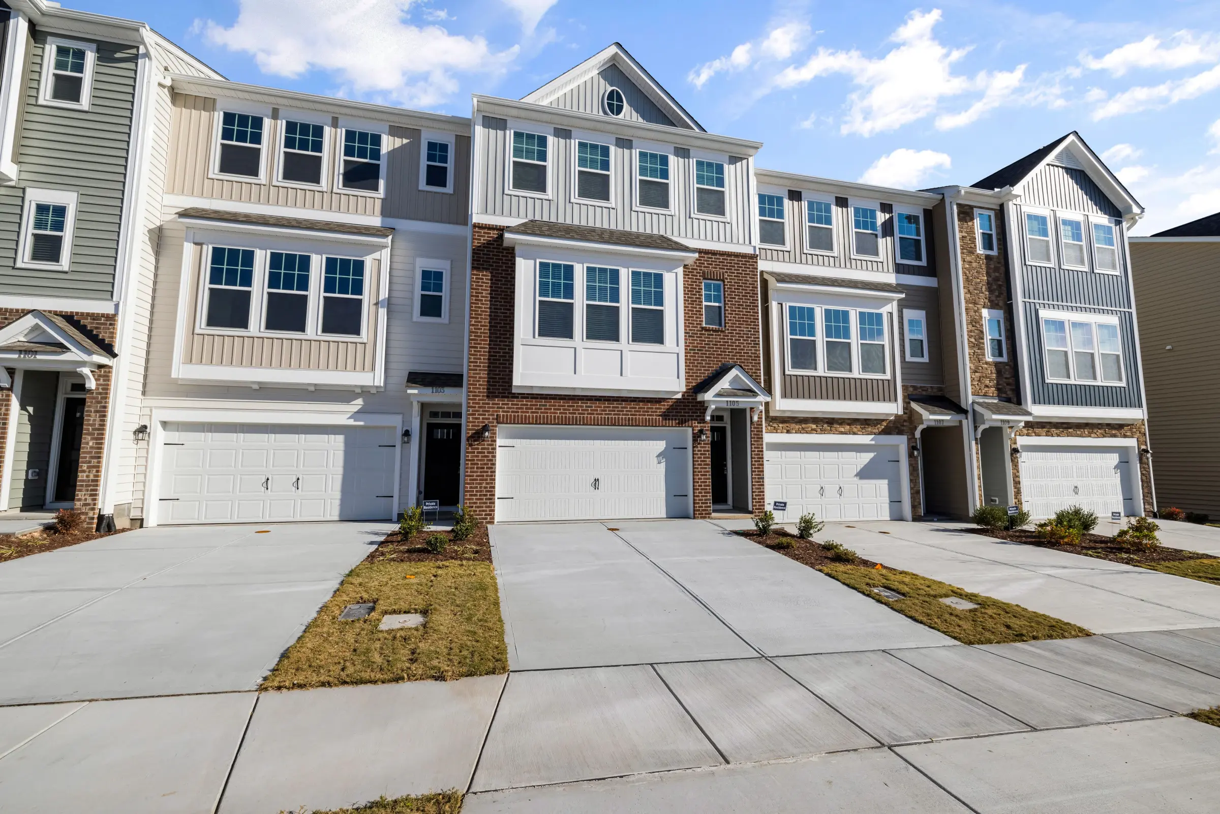 A row of newly built multi-family townhomes