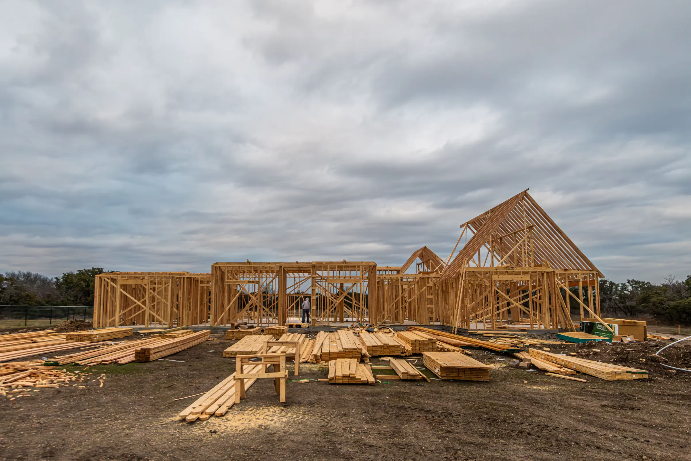 A single-family home being framed with lumber
